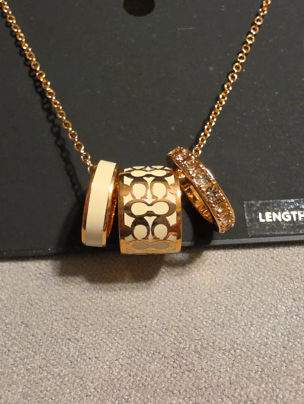 Coach Rose Gold-Tone Three-Ring Pendant Necklace